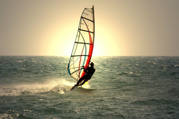 Windsurfing a lone sail with a man