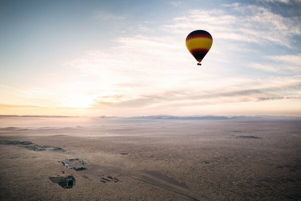 A bright balloon floats high above the ground