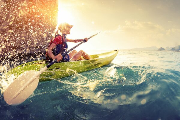 A girl on a kayak in sunny weather