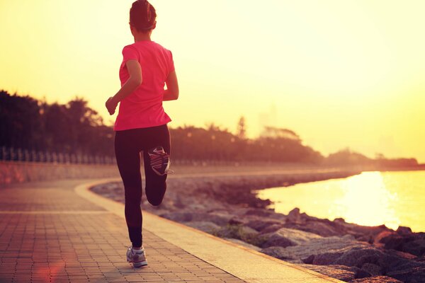 A woman runs along the shore