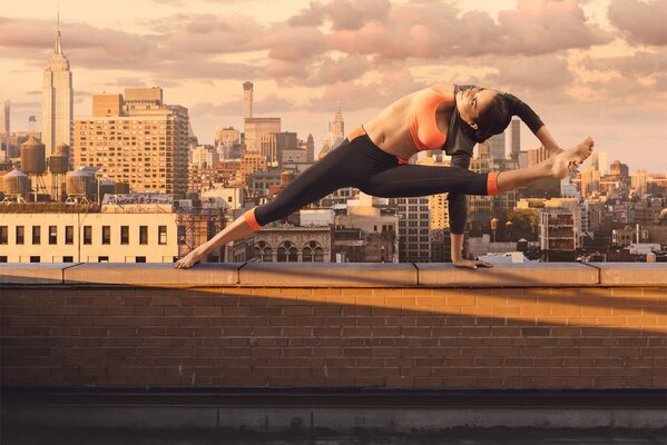 Girl doing stretching on the roof