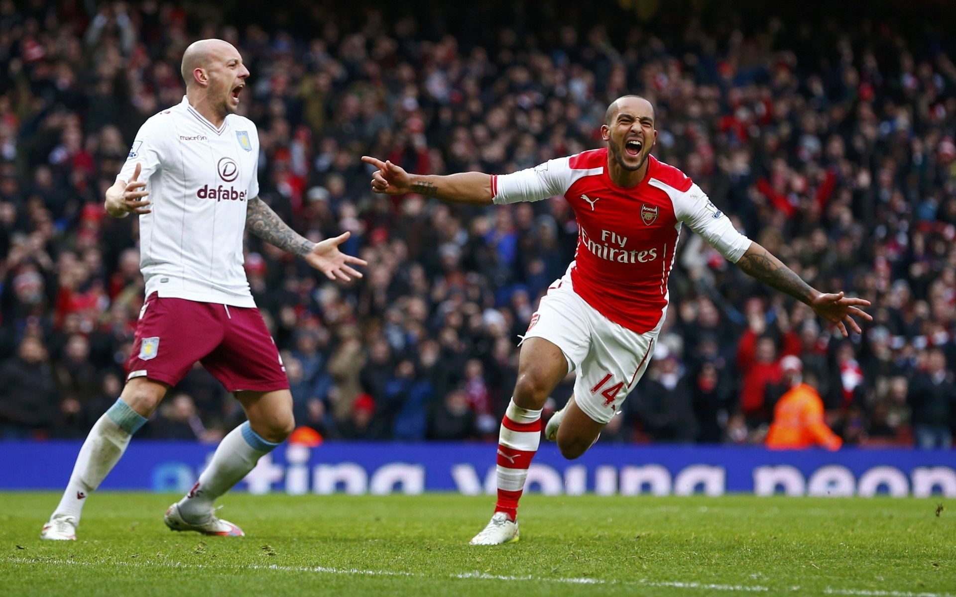 arsenal football club gunners players theo walcott stands background