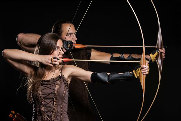 A woman uses a bow and arrow for shooting