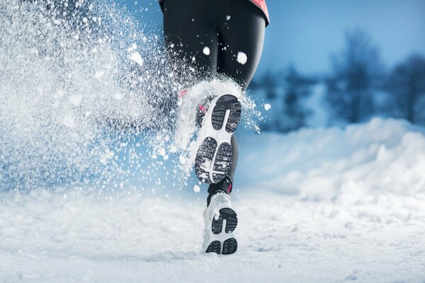 Running in sneakers on snow-covered roads