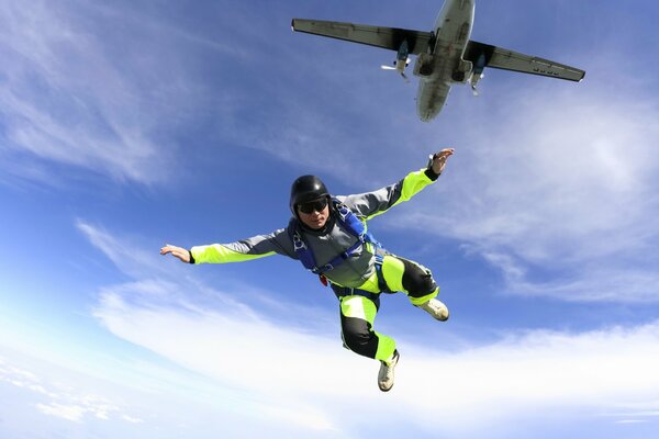 Photo of a parachutist in the sky jumping from an airplane