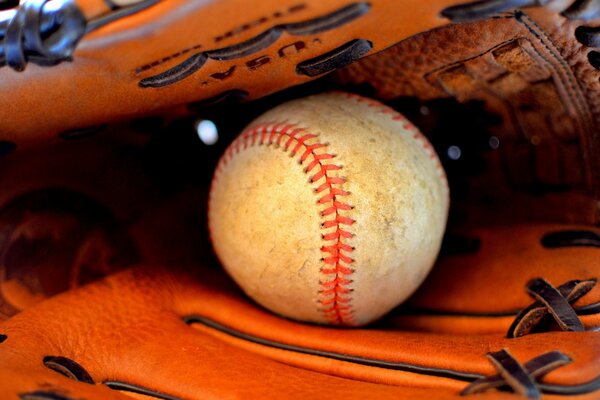 There is a stitched ball on the table