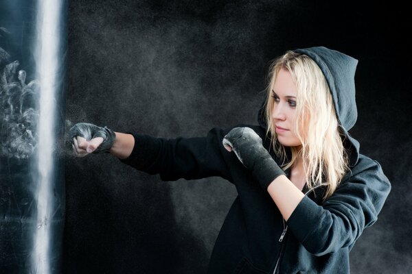 A young girl is learning boxing