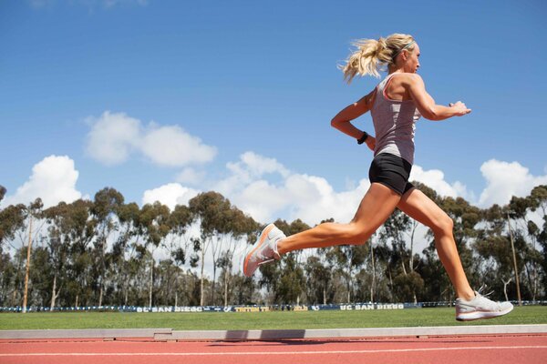 Running girl against the blue sky