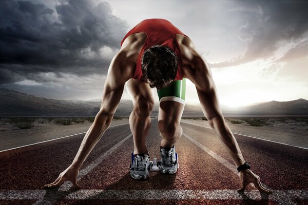 Athlete at the start against the background of clouds