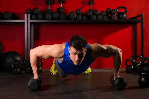 An athlete performs a push-up workout