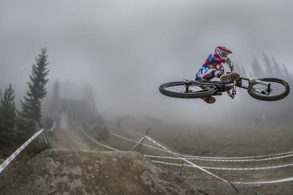 A cyclist on a foggy mountain track