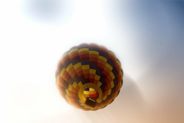 A balloon in a cloudy sky