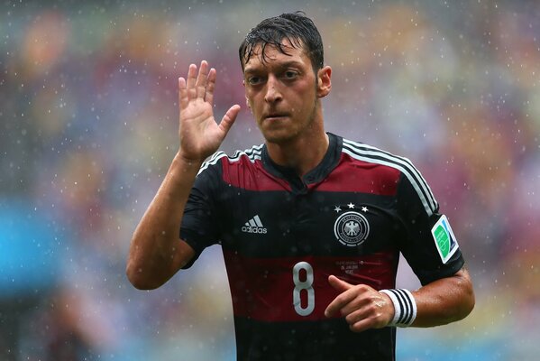 German football player under heavy rain