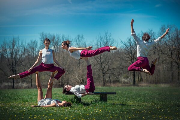 Gymnastics classes in nature. Performing jumps and splits