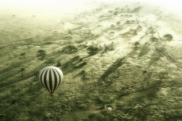 Striped balloon hovers above the ground