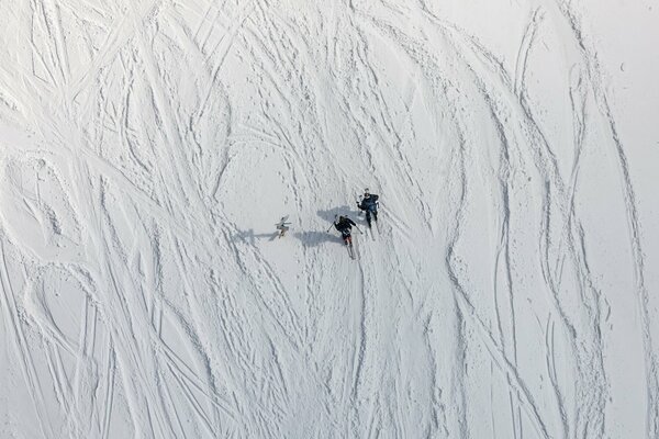 Skiers on the background of a snow massif