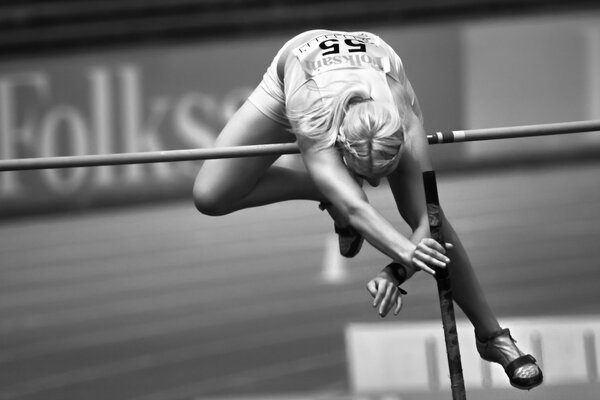 A female athlete jumping over the bar