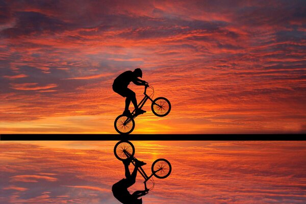 Reflection of a cyclist at sunset