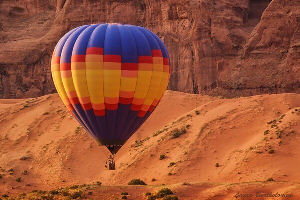 Balloon on the background of desert sand rocks