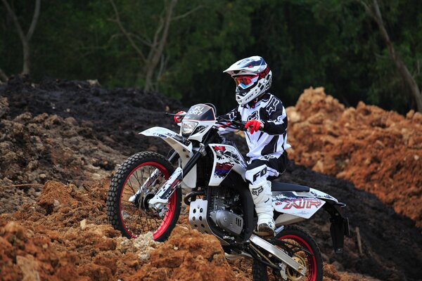 Racer on a black and white sports motorcycle