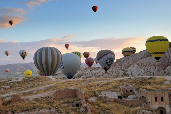 Somewhere in the mountains there is a blue sky strewn with balloons