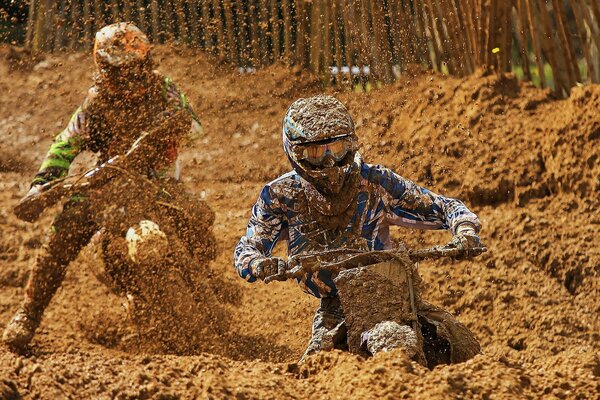 Racing sports motorcycles off-road in the mud