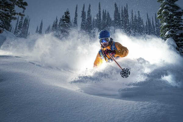 The skier put a turn on the descent from the snowy mountain