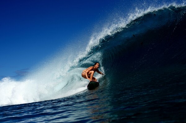 Chica en una tabla de surf conquista la ola
