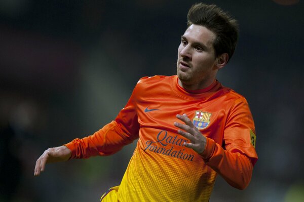 Waist photo of a running FC Barcelona football player Lionel Messi in a yellow-orange long sleeve T-shirt
