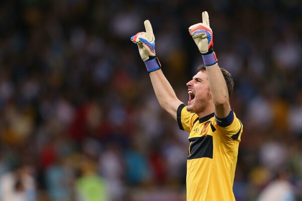 The goalkeeper of the football team screams with joy