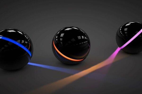 Три черных шара опоясанные светом разного цвета