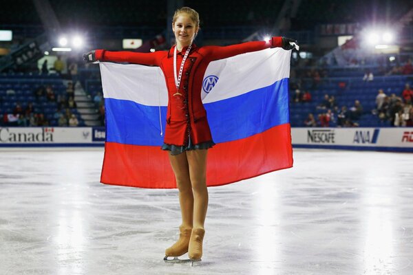 Figure skater Lipnitskaya with the flag of Russia