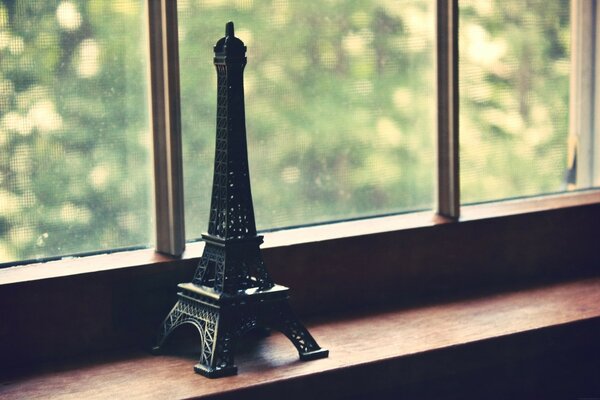 Statuette of the Eiffel Tower on the window