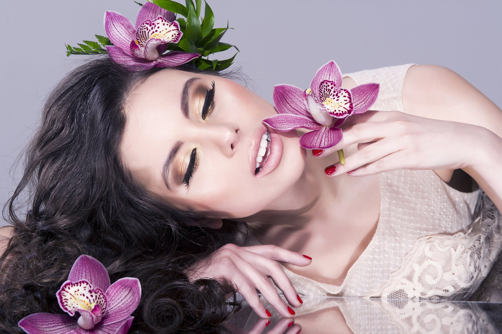 girl model beautiful make-up lips eyelash face. hair curls hand flower reflection manicure