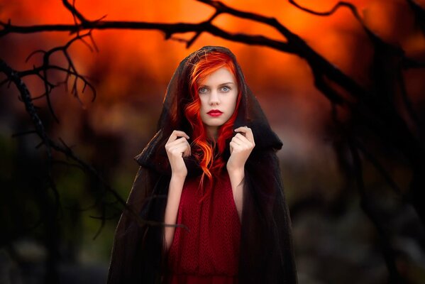 Portrait of a red-haired girl in a hood