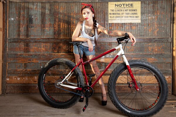 A model girl stands with a bicycle