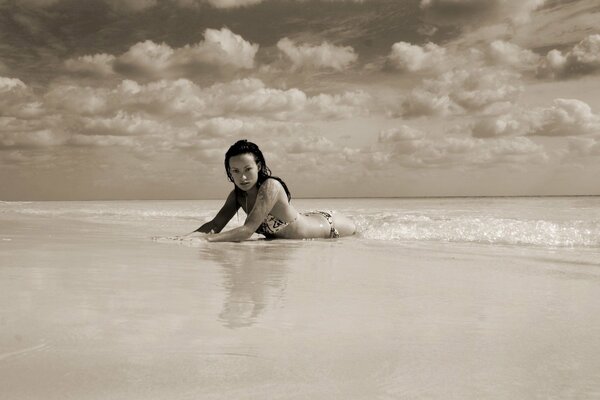 Olivia Wild in wet sand