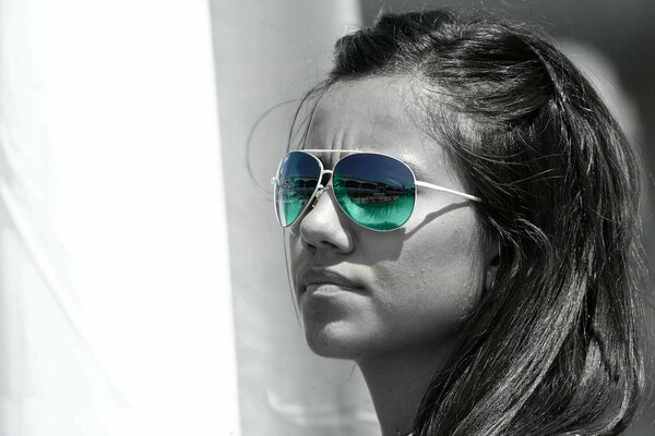 Girl in black and white effect and with colored glasses