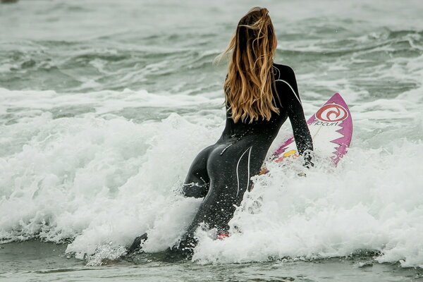 Girl on a surfboard in the waves