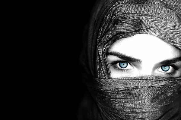 A girl in a hijab with blue eyes