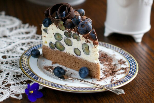 A piece of cottage cheese cake with grapes on a plate