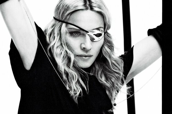 Madonna in a dress. In black and white style. Eye patch