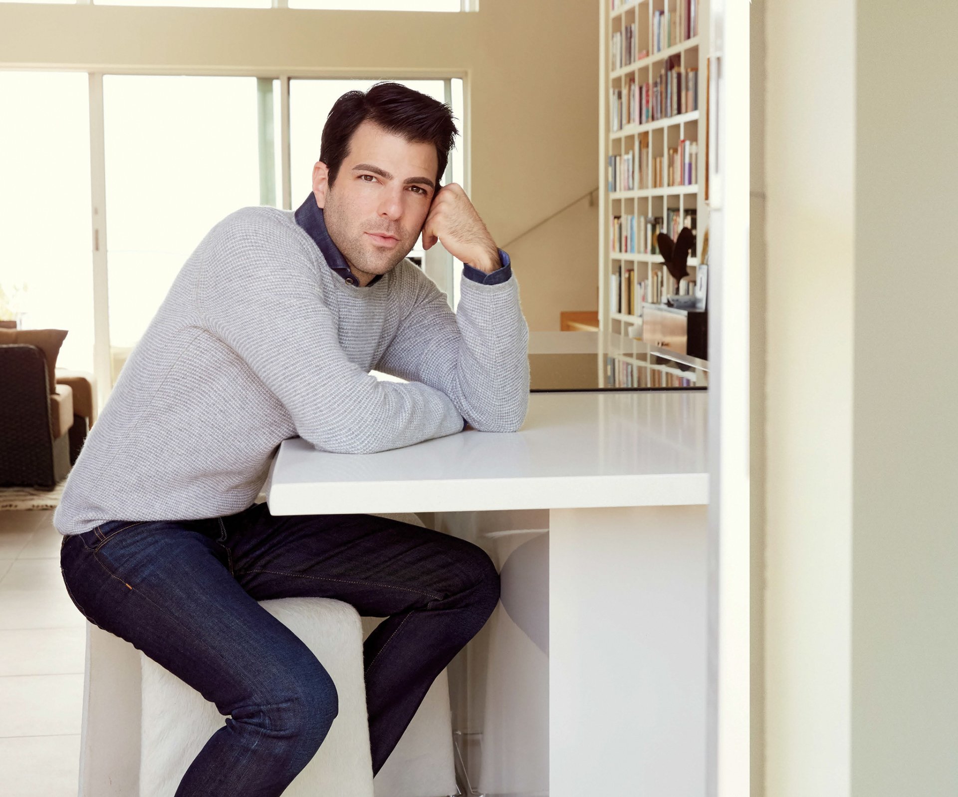 zachary quinto quinto actor sitting at the table jumper jeans photo shoot robert ascroft magazine hampton