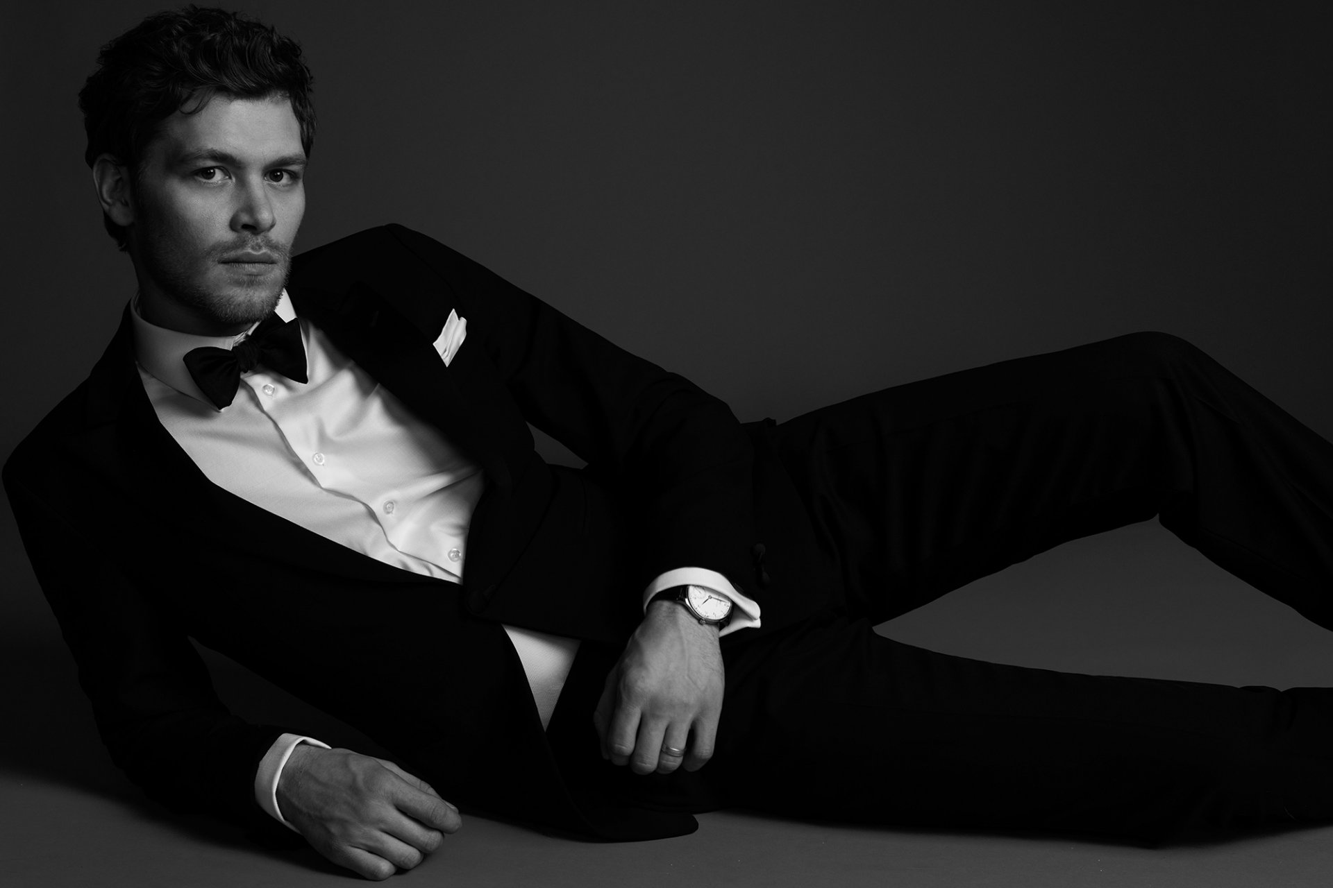 joseph morgan man tuxedo suit bow tie black and white actor lying pose watch shirt jacket trouser