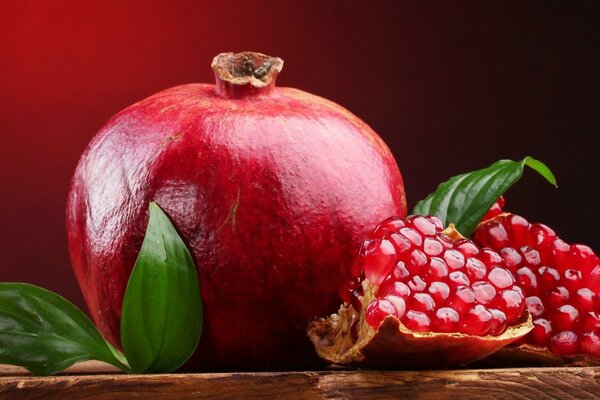 Still life ripe pomegranate with leaves 