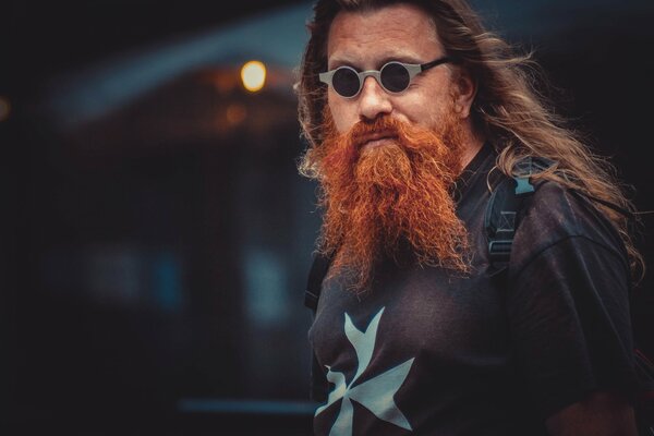 A brutal man with a red beard and glasses