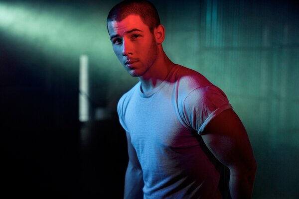 A pumped-up man poses for a photographer