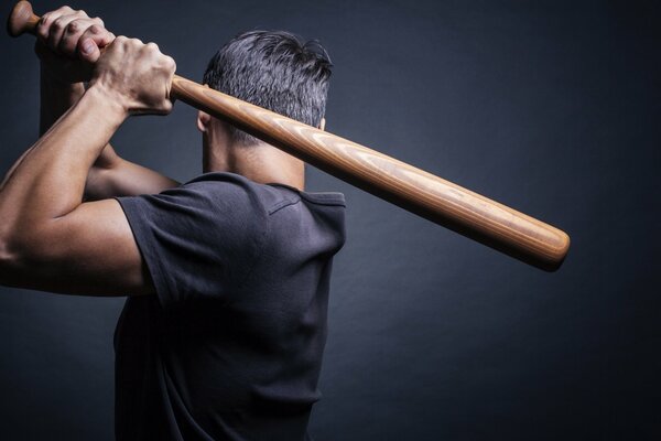 A man in a shirt with a baseball bat