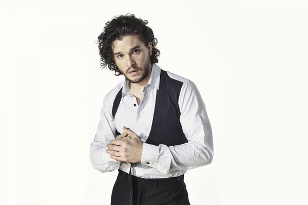 A man with curly hair in a shirt on a white background