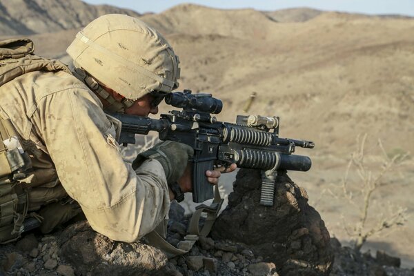 A US soldier with a gun on the ground